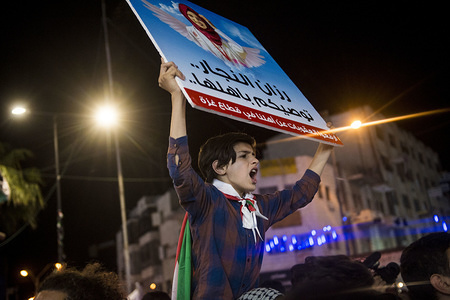 An anti-Abass protester holds a sign depicting Razan Al-Najar a nurse who was killed on during clashes at the Israeli-Gaza border.
Palestinians gathered in Al-Manara Square to march in protest of Mahmoud Abass and the Palestinian Authority. A group of pro-Abass supporters briefly scuffled with protesters, however the march remained peaceful after.