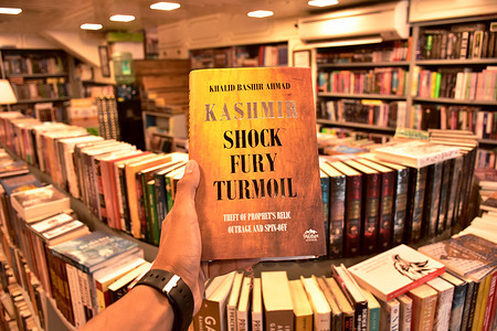 A person holds a book inside a book store. Indian authorities have banned 25 books that they say propagate false narratives and secessionism. The government accused the authors of misguiding the youth against India. Among the 25 banned books is one by Booker Prize winner Arundhati Roy, one of India’s most famous living authors.