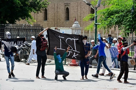 Kashmiri protesters display a flag during clashes with government forces in Srinagar, Indian administered Kashmir. Clashes erupted between Kashmiri protesters and Indian government forces soon after the Friday congregational prayers ended in the Grand Mosque in Srinagar.