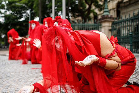 Extinction Rebellion Red Brigade protesters staged a performance during the demonstration in Brisbane.
Extinction Rebellion protesters vowed to disrupt the reopening of Queensland Parliament outside Parliament House in Brisbane City to call for an end to government corruption, urgent climate change action and for the abandoning of support for the Adani coal mine on the Queensland central coast. The internationally renowned group halts business as usual by way of blocking roads, organising rallies and disrupting mining operations in an effort to force political change.