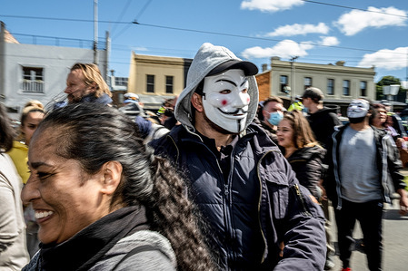 A protester looks on while wearing a mask at the Queen Victoria Market during the demonstration.More than 70 people have been arrested in Melbourne, Australia, for flouting the state's stay-at-home orders to attend an anti-lockdown protest. The demonstrations come as the state of Victoria prepares to ease its lockdown restrictions, which have been in place since early July.