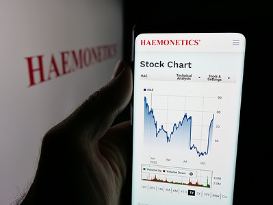 In this photo illustration, a smartphone with the web page of US healthcare company Haemonetics Corporation is seen on screen in front of logo.