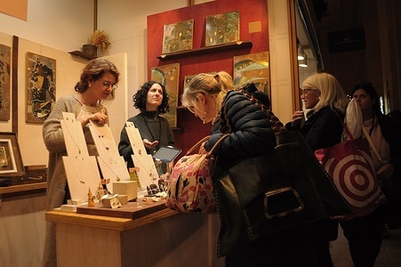 People are seen at a shop in Grand Central Holiday Fair in Grand Central Terminal, Manhattan, New York City.