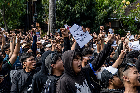 During the protest, students chant slogans while making fists on the streets near Udayana University. This protest was part of a nationwide movement after lawmakers scrapped a controversial plan to amend election rules. The plan was widely seen as an effort to help the outgoing president establish a political dynasty.