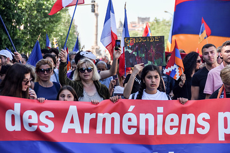 Demonstrators hold a banner and flags during an Armenian Genocide commemorative march in Marseille.Armenian citizens march towards the Turkish Embassy during a demonstration to mark the anniversary of the Armenian genocide.