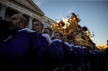 Prayers carry a statue of Jesus of Medinaceli in front of the Congress of Deputies. during a Good Friday procession of Jesus of Nazareth of Medinaceli in Madrid, Spain. The procession, organized by the Primary Archconfraternity of the Royal and Illustrious Slavery of Our Father Jesus of Nazareth of Medinaceli, is one of the largest of Madrid's Holy Week, and the Christ of Medinaceli is considered the Lord of Madrid.