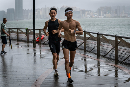 Joggers run along the promenade in Taikoo Shing during the Typhoon Wipha. The Hong Kong Observatory raised the highest typhoon warning signal, No. 10, as Typhoon Wipha lashed the city with hurricane-force winds, toppling hundreds of trees and damaging infrastructure. Dozens of people had sought medical treatment in public hospitals due to storm-related injuries, while over 240 residents took refuge in temporary shelters set up by the government.