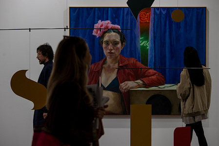 A woman walks past an exhibited artwork piece during the opening of ARCO (Spain's International Contemporary Art Fair) at its 45th edition at the IFEMA exhibition center.