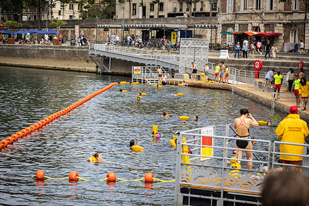 People swim at the Bras Marie safe bathing site on the Seine River on its opening day. A year after the Paris Olympics and 100 years after the last swim, the River Seine is once again a place where people can go swimming. Several people attended the inauguration for a first swim at the Bras Marie site near the Ile de Saint Louis.