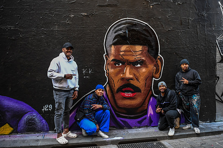 Recently retired NRL player from Melbourne Storm, Tui Kamikamica (L), is seen posing next to a mural of him in Hosier Lane, Melbourne CBD. A street art mural by Melbourne-based Samoan/Polynesian artist Jeremy Lepua, also known as Lepua Design, honors Melbourne Storm prop Tui Kamikamica. The artwork celebrates Kamikamica's NRL career and Pacific Islander heritage and is located in Melbourne's Hosier Lane.