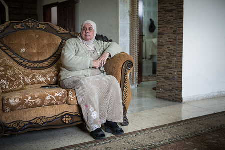 Aunt of Ahed Tamimi sitting on a sofa.
Ahed Tamimi has been in prison since December 2017, she is a teenage activist in Palestine and her mother was arrested too. Her family stays in Nabi Salih, a village north of Ramallah, there is a population of about 600 people, all activists and all are part of the same family.