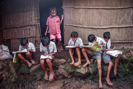 Tribal Kids study during a break at small Tribal Hamlet of Dhamanwadi outside there home near the school as World celebrates International Literacy day across the world on 8th September this years theme is Literacy and Skill development on the outskirts of Thane.