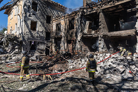 Firefighters put out fire in a residential building following a Russian air strike. Russian air strikes on residential areas leave destruction and distress in their wake, as firefighters battle flames and civilians pass damaged buildings in the aftermath of the attack.