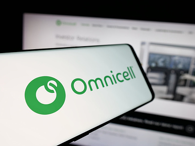 In this photo illustration, a smartphone with the logo of healthcare technology company Omnicell Inc. is seen on screen in front of website.