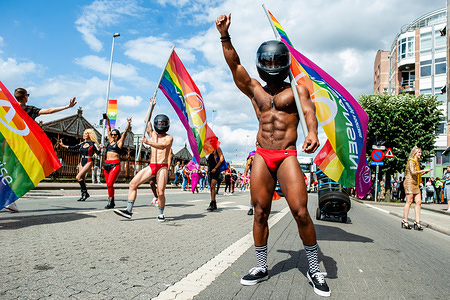 A man in underpants holding a rainbow flag during the parade.
Antwerp Pride commemorates and celebrates the long journey forwards acceptance and equal opportunities the LGBT+ community has made. Antwerp Pride attracts thousands of people to the city every year.