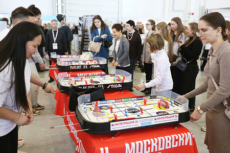 Participants and visitors seen playing table hockey during 10th International Exhibition of Equipment and Technology for Rehabilitation and Care. Intergration Moscow is an international specialized exhibition of innovative technologies for social adaptation and rehabilitation of people with disabilities, limited health and developmental disabilities. The event brings together more than 4000 visitors from 7 countries and 144 exhibitors.