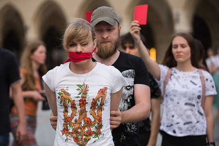 An Ukranian girl with a red scarve covering her mouth attends a  protest demanding the release of the Ukrainian filmmaker and writer,Oleg Sentsov at the Main Square in Krakow.
Oleg Sentsov was sentenced by a Russian court on 25 August 2015 to 20 years for planning a terrorist attack at the Crimea peninsula annexed by Russia in April 2014.