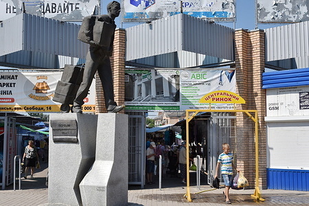 A young boy cools off at a mist spray arc as the maximum temperature exceeds 37 degrees in Slavyansk.