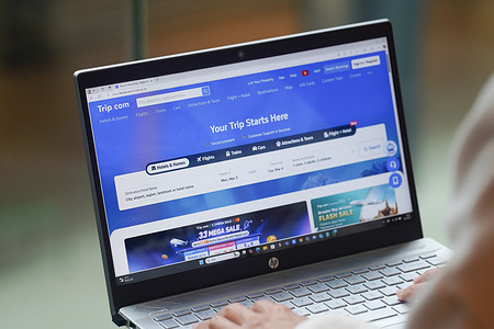 In this photo illustration, A woman browses Trip.com website on her laptop.
