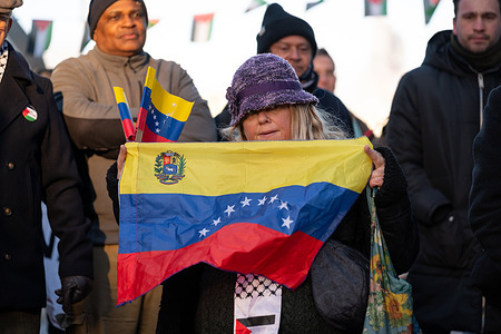 A protester holds the Venezuelan flag during the demonstration. Protesters gathered outside the US Embassy in London to oppose US military action against Venezuela and the reported capture of President Nicolas Maduro, denouncing what they described as foreign intervention driven by geopolitical interests. Demonstrators accused the Trump administration of targeting Venezuela over control of oil resources and drug trafficking narratives, calling for respect for sovereignty and an end to US aggression.