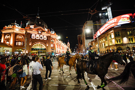 Horse-mounted officers oversee the busy scene near Flinders Street Station, ensuring public safety during the festive night. After the spectacular New Year’s fireworks, the crowd flows toward Flinders Street Station, heading home as the celebrations wind down.