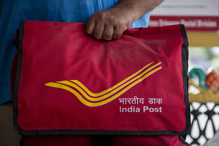 A Postman seen carrying a bag outside the India Post office. India Post has announced it will discontinue its iconic Registered Post service from September 1 2025, merging it with the Speed Post service and ending a trusted mode of communication that served the nation for more than five decades. The move is part of efforts to modernize postal operations and adapt to changing communication trends. Launched more than 50 years ago, Registered Post became a staple used by government offices, courts and millions of citizens especially in rural India to send job offer letters, legal notices and personal communication with proof of delivery and added security.