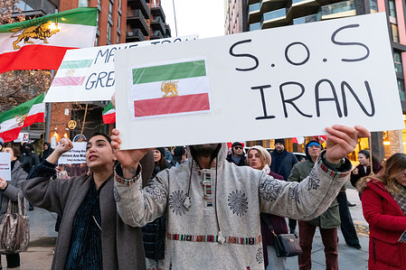A protester holds a placard that reads "S.O.S. Iran" during a demonstration. Members of the Iranian diaspora gathered outside the US Embassy in London following recent anti-government protests in Iran, calling on US President Donald Trump to help bring an end to the Islamic Republic. Demonstrators urged support for regime change and voiced support for the return of Shah Pahlavi and the restoration of the monarchy, waving Iranian flags and chanting slogans against the current leadership in Tehran.
