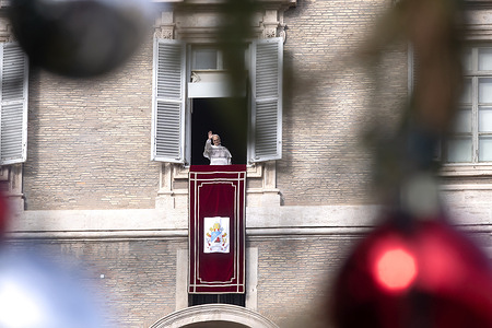 Pope Leo XIV delivers the Angelus prayer from the window of his studio overlooking St. Peter's Square.