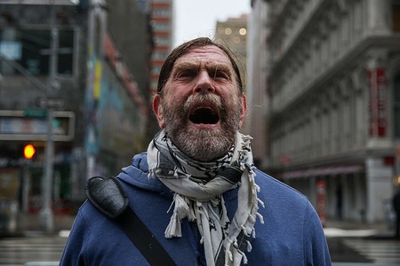 A participant in the “Jericho Walk” shouts in protest against the treatment of immigrants, in front of 26 Federal Plaza, one of New York's immigration courts. Every Thursday at 11 a.m., a small group of New Sanctuary Coalition activists holds the “Jericho Walk”: 90 minutes of silent prayer around the Federal Plaza Immigration Court building, followed by a public reading and a collective shout against the immigration system. New Sanctuary Coalition is a New York faith-based organization that offers moral and administrative support to immigrants facing deportation and detention, accompanying them as they exit the immigration court.