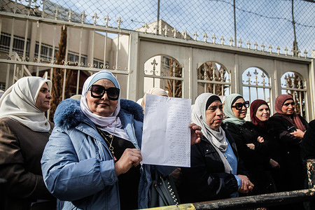 Palestinian school teachers stand in front of their closed school during a protest, demanding their rights, in the city of Nablus in the occupied West Bank. Teachers in the West Bank have been on strike for over a month. They rejected a settlement offering to pay 85% of their salaries, saying the government has failed to meet its promises and should pay their salaries in full. As a result of the strike, over a million Palestinian students have not been able to attend school.