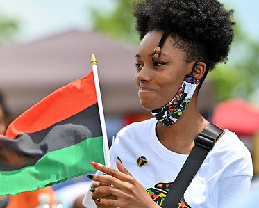 A young black woman holds a Black Liberation Flag during a Juneteenth celebration.
President Joe Biden signed into law legislation that would establish June 19 as Juneteenth National Independence Day. Juneteenth is the celebration of the emancipation of blacks. Scranton held a block party for families to celebrate the holiday.