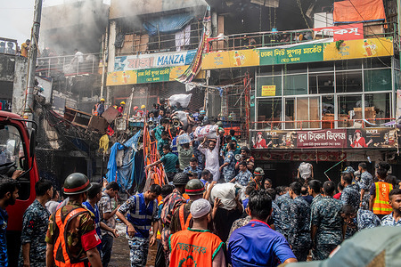 Business owners bring out their goods from the site of a fire at the New Supermarket in Dhaka. A massive blaze has gutted shops in Dhaka's New Supermarket, one of the largest clothing markets in the country, ahead of Eid-ul-Fitr. Emergency personnel from the Army, the Air Force, Rapid Action Battalion, Bangladesh Police and Border Guard Bangladesh joined forces with 28 Fire Service and Civil Defence units to try and tame the flames on Saturday.