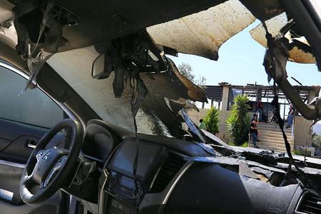 A burned Palestinian vehicle is seen in front of a Palestinian home after it was set on fire following an attack by a group of Jewish settlers in the village of Osarin, south of Nablus in the West Bank. The settlers attacked homes, torched a Palestinian car in the early morning hours, and wrote Hebrew slogans on the walls calling for revenge against Palestinians.