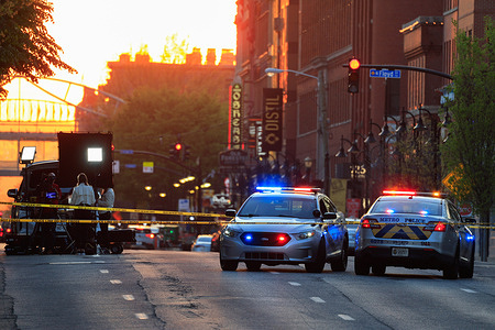 Police cars and cordon tape block Main Street near the Old National Bank after a mass shooting in Louisville, Kentucky. A gunman opened fire inside the bank, killing four people and wounding nine.