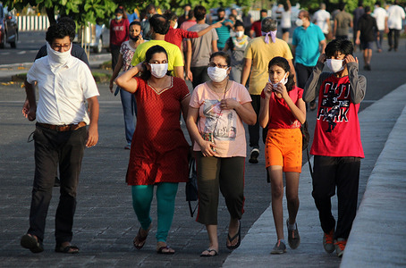 People walk along the sea facing promenade after the ease of lockdown.
Indian government eased lockdown restrictions in a phased manner reopening its restaurants, shopping malls and religious places in many of its state after more than two months of lockdown even as the country witnesses a rise in new coronavirus infected cases.