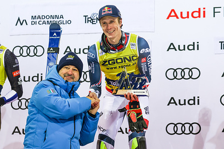 Clement Noel of France celebrates the victory with Matteo Savini Minister of Infrastructure and Transport in the Italian Government during Audi FIS Alpine Ski World Cup men's slalom at 3Tre ski slope in Madonna di Campiglio.