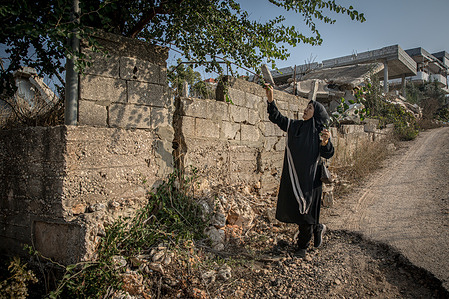 Zainab, beside what remains of her family home in Ayta al-Shaab, close to Lebanon's border with Israel. November 27, 2025, will mark the first anniversary of the ceasefire between Israel and Hezbollah. By the beginning of November 2025, UNIFIL recorded almost 7,100 Israeli air violations of UN resolution 1701. UNIFIL also said there had been more than 2,400 “activities” by the IDF inside of Lebanon, while they had discovered around 360 weapons caches - mostly presumed to belong to Hizbullah. 
More than 270 people have been killed and around 850 wounded by Israeli actions since the ceasefire, according to Lebanon’s ministry of health. The UN human rights office verified at least 107 of them as civilians or noncombatants by October 9.