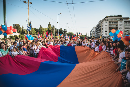 Protesters holding the huge Armenian flag during a demonstration to mark the 103rd anniversary of the Armenian Genocide by Turkey. Protesters marched to Syntagma Square, to deliver a memo to the Turkish Ambassador.