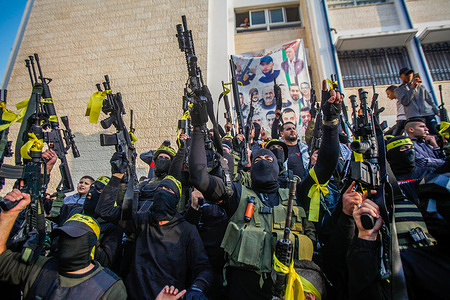 Palestinian gunmen from the Balata Brigade of the Fatah movement and Groups of lions' den carry their weapons and show off their strength during a memorial ceremony of the Palestinian gunmen killed by the Israeli army at the Askar refugees camp in the West Bank.