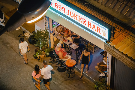 A view above the "899 Joker Bar", a hostess bar, during the night at Soi Buakhao. Pattaya has a vibrant nightlife, with many host bars, go-go bars, massage parlors, saunas, and hourly hotels enveloping the city. These establishments cater to both foreign tourists and locals, contributing to the area's vibrant atmosphere.