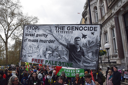 Protesters hold an anti-Israel 'Stop the genocide' banner during the demonstration. Tens of thousands of people marched against the far right, fascism and racism, and in support of migrants.
