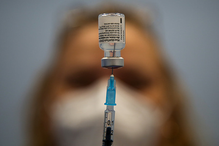 A healthcare worker prepares a dose of Pfizer, coronavirus (Covid-19) vaccine at a vaccination centre in London.
