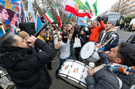 Protesters chanting and playing drums during the rally. Hundreds of demonstrators gathered outside the Republic of Iran Embassy in central London as part of a wave of anti-government protests in Iran. Protesters chanted slogans and held placards condemning the Iranian authorities, expressing solidarity with demonstrators inside the country and calling for political change, human rights, and an end to repression.