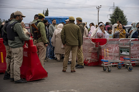 Indian policemen seen standing guard behind barricades at the entrance of Hajj House as pilgrims depart for Hajj . The first batch of 435 pilgrims from Jammu and Kashmir has set out on the sacred journey of Hajj to Mecca. This year, a total of 175,025 pilgrims from India will perform Hajj, including 4,704 pilgrims from Jammu and Kashmir.