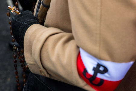 An attendee prays the Rosary before the march begins. On the afternoon of the 11th of November, Polish citizens from all over the country marched through the streets of Warsaw to celebrate Independence Day. The event is estimated to gather 100 thousand participants, with patriotic Poles gathering to celebrate. Many families bringing their children. The march has religious undertones with much religious symbolism seen in flags and banners. Many far-right and fascist organisations also marched. This year, Polish member of the European Parliament Dominik Tarczynski invites English far-right activist Tommy Robinson who attended with a number of his supporters. The march itself was initiated by far-right groups and has been marred by controversy as it is seen by many as promoting fascism, antisemitism and racism. This year, the crowds gathered at Warsaw's Roman Dmowski roundabout and marched towards the PGE National Stadium.