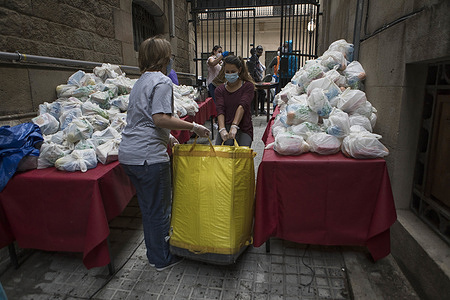 Volunteers from the Santa Anna convent prepare to deliver bags of food during the Coronavirus (COVID-19) crisis.
Volunteers from the Santa Anna convent, located in the center of Barcelona, distribute more than 200 meals a day to homeless people and people who lost their jobs due to coronavirus crisis.