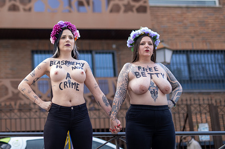 (EDITOR'S NOTE : Image contains nudity)
Two topless Femen activists raise their fists in front of the Moroccan Consulate in Madrid to protest in demand of the release of Moroccan activist Ibstissame Lachgar, known as "Betty," for the crime of "offending the Islamic religion" after posting an image with the phrase "Allah is a lesbian." Lachgar, co-founder of the Alternative Movement for Individual Freedoms (MALI), was arrested on August 10 in Casablanca and later transferred to a prison in Rabat.