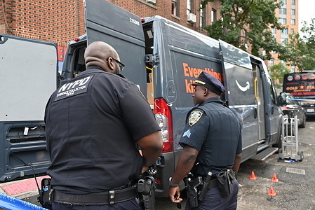 NYPD officers seen at the scene, where a 31-year-old Amazon delivery driver was shot in the ankle near East Tremont Avenue and Bryant Avenue, within the 48th Precinct in the Bronx. The shooting happened at 2:37 PM and the victim is in stable condition. Several shots were fired and no suspects are currently in custody. Multiple bullet holes were discovered on the Amazon van. Shell casings also were discovered inside of the back of the Amazon van between packages.