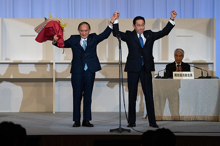 TOKYO, JAPAN - SEPTEMBER 29: Former Japanese Foreign Minister Fumio Kishida (R) celebrates with outgoing Prime Minister, Yoshihide Suga, after being announced the winner of the Liberal Democrat Party leadership election on September 29, 2021 in Tokyo, Japan. Prime Minister Suga’s replacement will be Japan’s third leader during the coronavirus pandemic and is likely to be heavily focussed on getting the country’s economy back on track. (Photo by Carl Court/Getty Images)