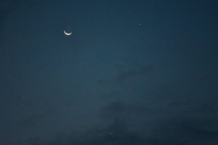 The crescent moon along with the planets Venus and Jupiter are seen during a rare conjunction in Srinagar, the summer capital of Jammu and Kashmir.